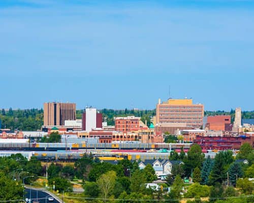 Cheyenne downtown skyline with train cars, houses, and trees in view. Cheyenne downtown skyline with train cars, houses, and trees in view.